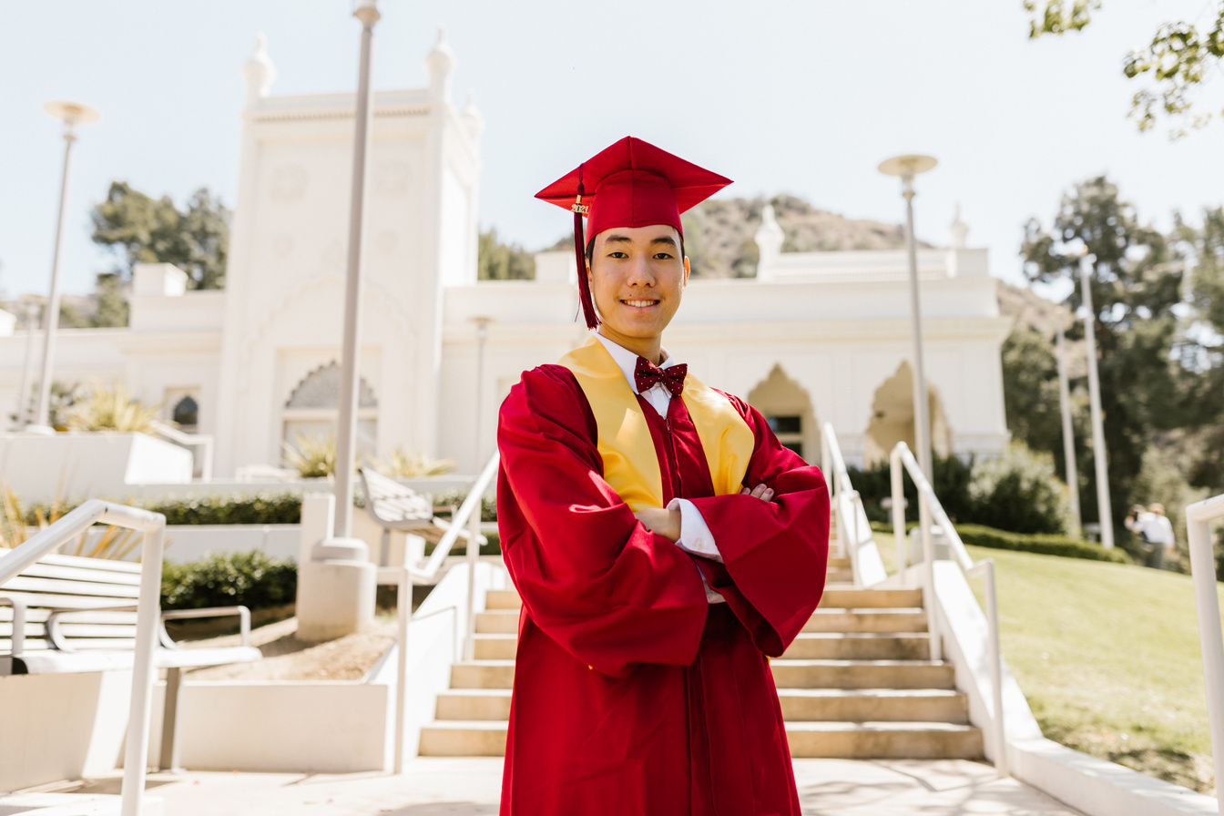 Boy Wearing Red Graduation Gown and Graduation Cap